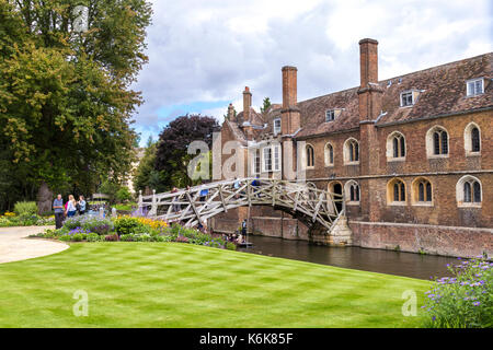 Mathematical Bridge and people punting on the Cam river, Queen's College building, Cambridge, UK Stock Photo