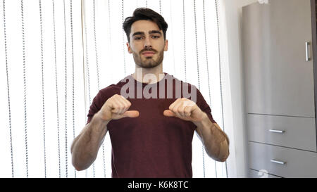 Handsome young man pointing finger at himself, smiling Stock Photo
