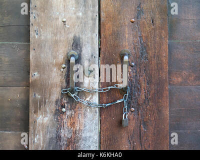 old closed wooden door with chain and padlock Stock Photo