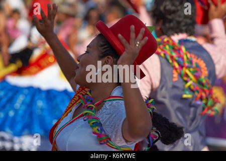 Pueblo dance group in ornate costume performing at the annual Carnaval Andino con la Fuerza del Sol in Arica, Chile. Stock Photo