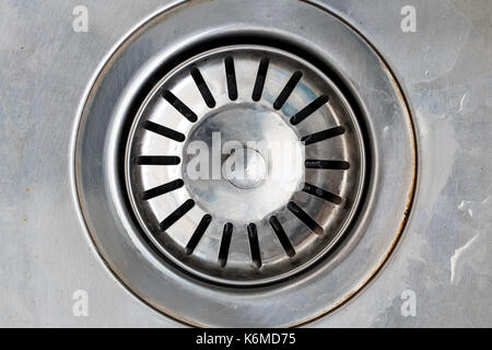 Drain hole in metal sink, macro view. Mechanically adjustable drain plug closeup. Stock Photo