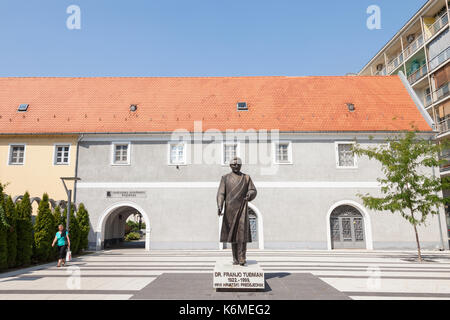 OSIJEK, CROATIA - AUGUST 26, 2017: Woman passing by a statue of Franjo Tudman. Franjo Tudjman was the first president of Croatia, during the 90's  Fra Stock Photo