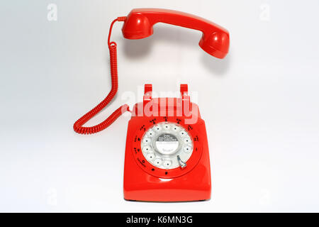 Retro rotary dial phone on call with no body, hang up by hollow man Stock Photo