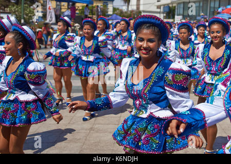 Caporales dancers in ornate costumes performing at the annual Carnaval Andino con la Fuerza del Sol in Arica, Chile. Stock Photo