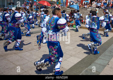 Caporales dancers in ornate costumes performing at the annual Carnaval Andino con la Fuerza del Sol in Arica, Chile. Stock Photo