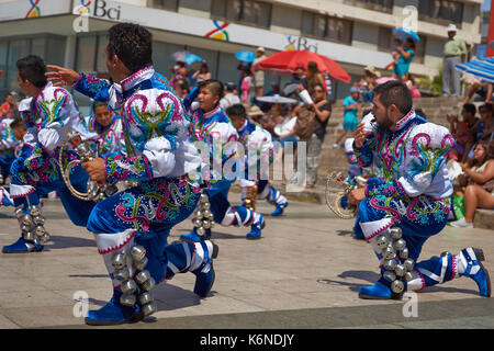 Caporales dancers in ornate costumes performing at the annual Carnaval Andino con la Fuerza del Sol in Arica, Chile. Stock Photo