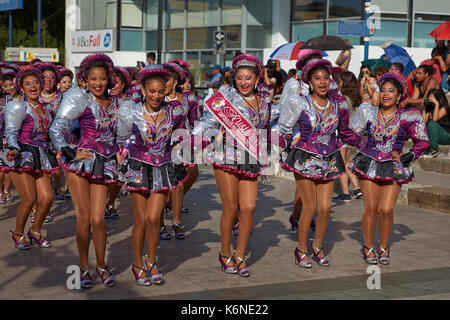 Caporales dancers in ornate costumes performing at the annual Carnaval Andino con la Fuerza del Sol in Arica, Chile. Stock Photo