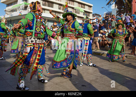 Tinkus dancers dressed in ornate costumes performing during a street ...