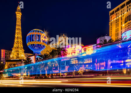 Las Vegas Strip Light Show -  Light streaks from vehicular traffic in the Las Vegas Strip in Nevada along with the illuminated Paris Las Vegas Hotel a Stock Photo