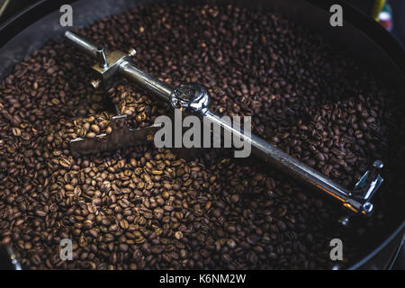 Process of roasting and mixing coffee. Coffee beans In the roaster Stock Photo