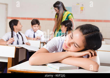 1 Indian Girl High School Student Sleeping In Classroom Stock Photo