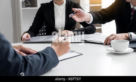 Businessman conducting an interview with businessman in an office. Stock Photo