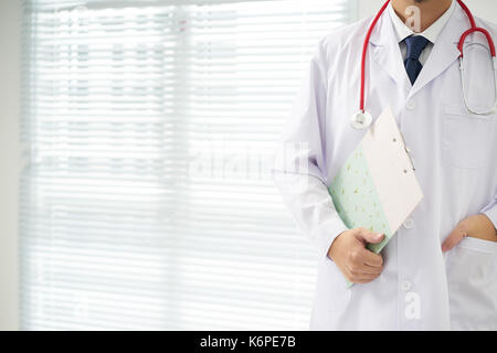 Doctor with a stethoscope and taking notes with bright background . Stock Photo