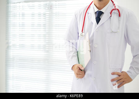 Doctor with a stethoscope and taking notes with bright background . Stock Photo