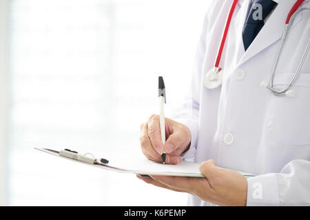 Doctor with a stethoscope and taking notes with bright background . Stock Photo
