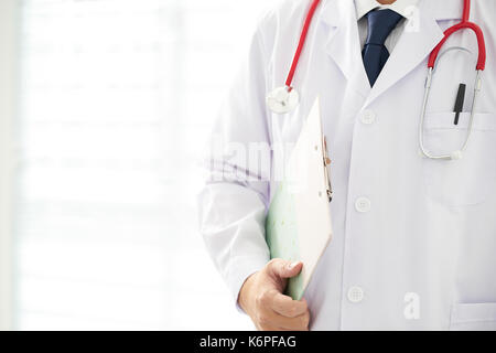 Doctor with a stethoscope and taking notes with bright background . Stock Photo