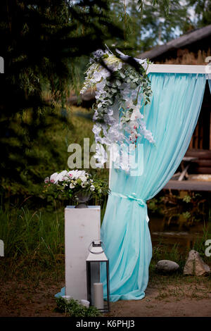 Wedding Arch of turquoise color on background lake Stock Photo