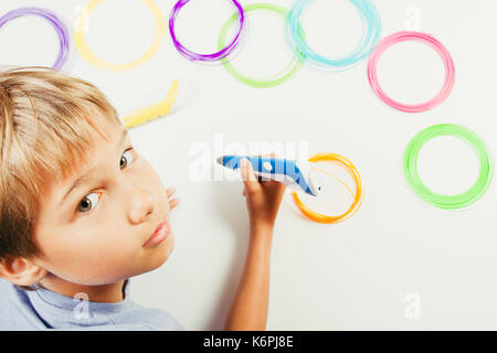 Kid creating with 3d printing pens Stock Photo - Alamy