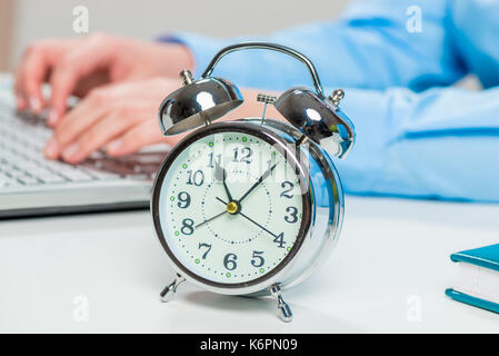Retro alarm clock on the desktop in the office close-up Stock Photo