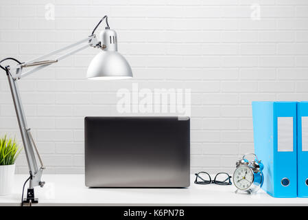 Open laptop on a white desktop in the office no people Stock Photo