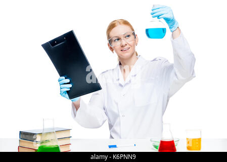 beautiful woman lab assistant with test tubes and a folder at the table while working Stock Photo
