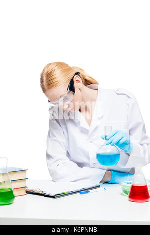 Girl chemist lab assistant doing analysis at the table Stock Photo