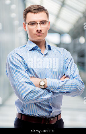 Vertical portrait of confident businessman with glasses in office Stock Photo
