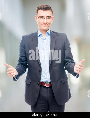 Joyful happy entrepreneur in office showing gesture with hands Stock Photo