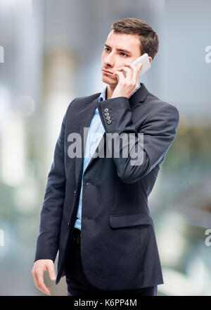 Businessman talking on the phone in office Stock Photo