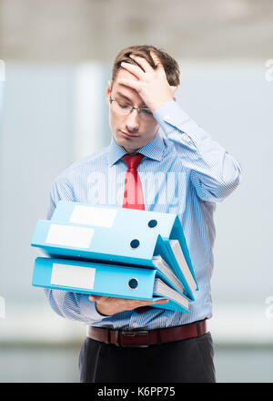 Tired and frustrated chief accountant with documents in the reporting period in the office Stock Photo