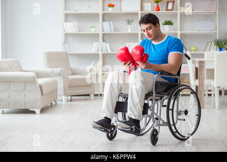 Disabled boxer at wheelchair recovering from injury Stock Photo