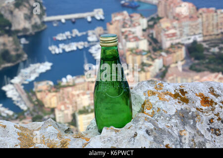 La Turbie, France - June 1, 2016: Perrier Sparkling Natural Mineral Water. Aerial View of the Port of Fontvieille in Monaco in the Background Stock Photo