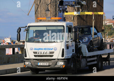 Nessebar, Bulgaria - July 16, 2016:  Tow Truck Iveco Eurocargo Takes Away Illegal Parked Car in The Town of Nessebar in Bulgaria Stock Photo