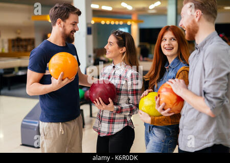 Friends having great time playing bowling Stock Photo