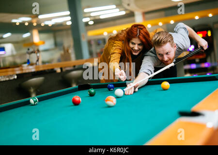 Couple playing billiards Stock Photo