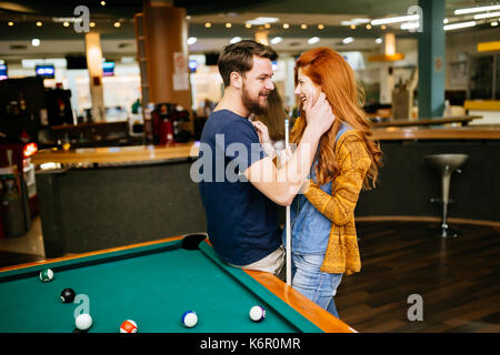 Couple hugging in snooker bar Stock Photo