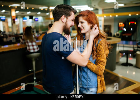 Couple hugging in snooker bar Stock Photo
