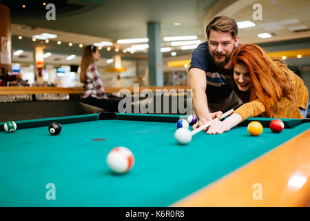 Couple playing billiards Stock Photo