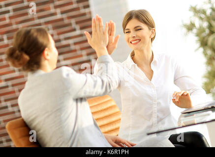 members of the business team giving each other a high five. Stock Photo