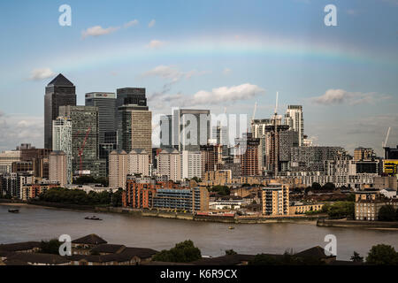 London, UK. 13th Sep, 2017. UK Weather: Colourful rainbow breaks over Canary Wharf business park buildings in east London during an afternoon rainstorm. Credit: Guy Corbishley/Alamy Live News Stock Photo