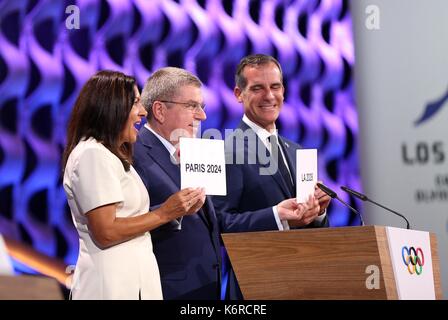 Lima, Peru. 13th Sep, 2017. International Olympic Committee President Thomas Bach (C) poses for photos with Anne Hidalgo (L), Mayor of Paris, and Eric Garcetti, Mayor of Los Angeles, at the 131st IOC session in Lima, Peru, on Sept. 13, 2017. The International Olympic Committee (IOC) has confirmed Paris and Los Angeles as the Summer Olympics host cities for 2024 and 2028 respectively, through a vote by a show of hands on Wednesday in Lima, Peru. Credit: Li Ming/Xinhua/Alamy Live News Stock Photo