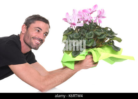 man giving a pink Cyclamen in front of white background Stock Photo