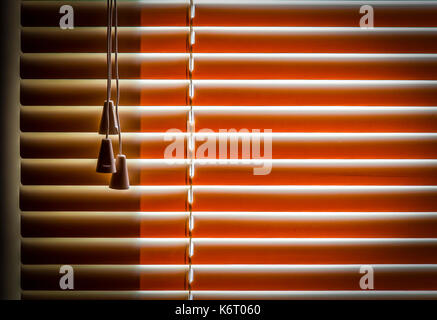 Orange plastic horizontal blinds close-up as a background. Stock Photo