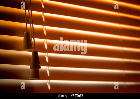 Orange plastic horizontal blinds close-up as a background. Stock Photo