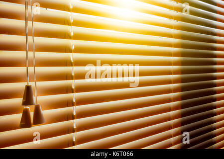 Orange plastic horizontal blinds close-up as a background. Stock Photo