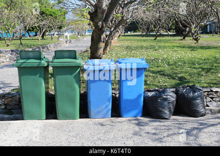 plastic trash bin and Black garbage bag placed in the park,concept of cleanliness. Stock Photo