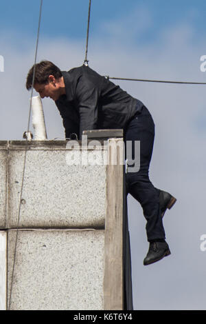 Tom Cruise leaps from the roof of one building to another while filming the next film in the 'Mission: Impossible' series; Cruise appeared to injure himself in the stunt and required medical treatment.  The 55-year-old action man was injured during a big building-jump stunt on the set of the blockbuster in London on Sunday (13Aug17) - which was caught on camera. Cruise appeared to miss his mark while jumping from construction rigging onto a nearby building, and slammed gainst the wall. Clambering up the wall and getting to his feet, the movie star limped for a few yards and then collapsed in  Stock Photo