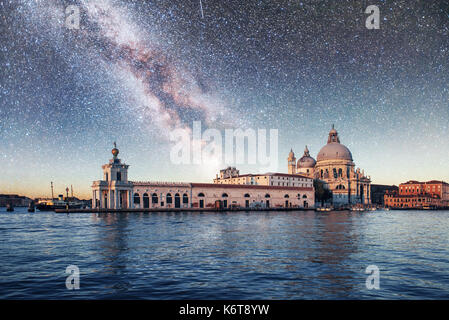 Gondolas on the canal at night in Venice, San Giorgio Maggiore church. San - Marco. Fantastic starry sky and the Milky Way Stock Photo