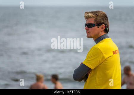 Sarbinowo, Poland -  August 2017 : Lifeguard on the beach observing swimmers in the sea Stock Photo