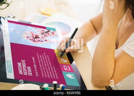 web designer working on a tablet. All screen graphics are made up. Stock Photo
